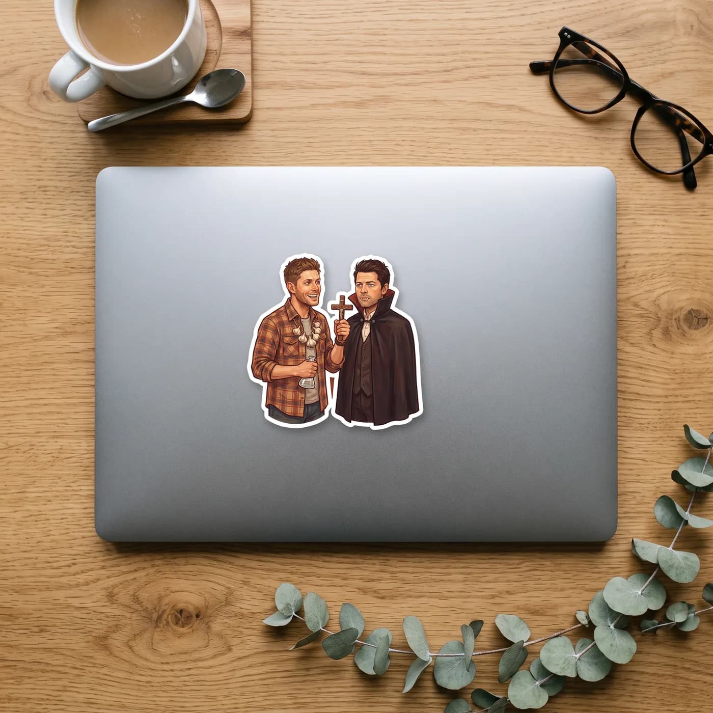 Castiel wears a spooky vampire costume while a grinning Dean protects himself with a hefty garlic necklace., view 2