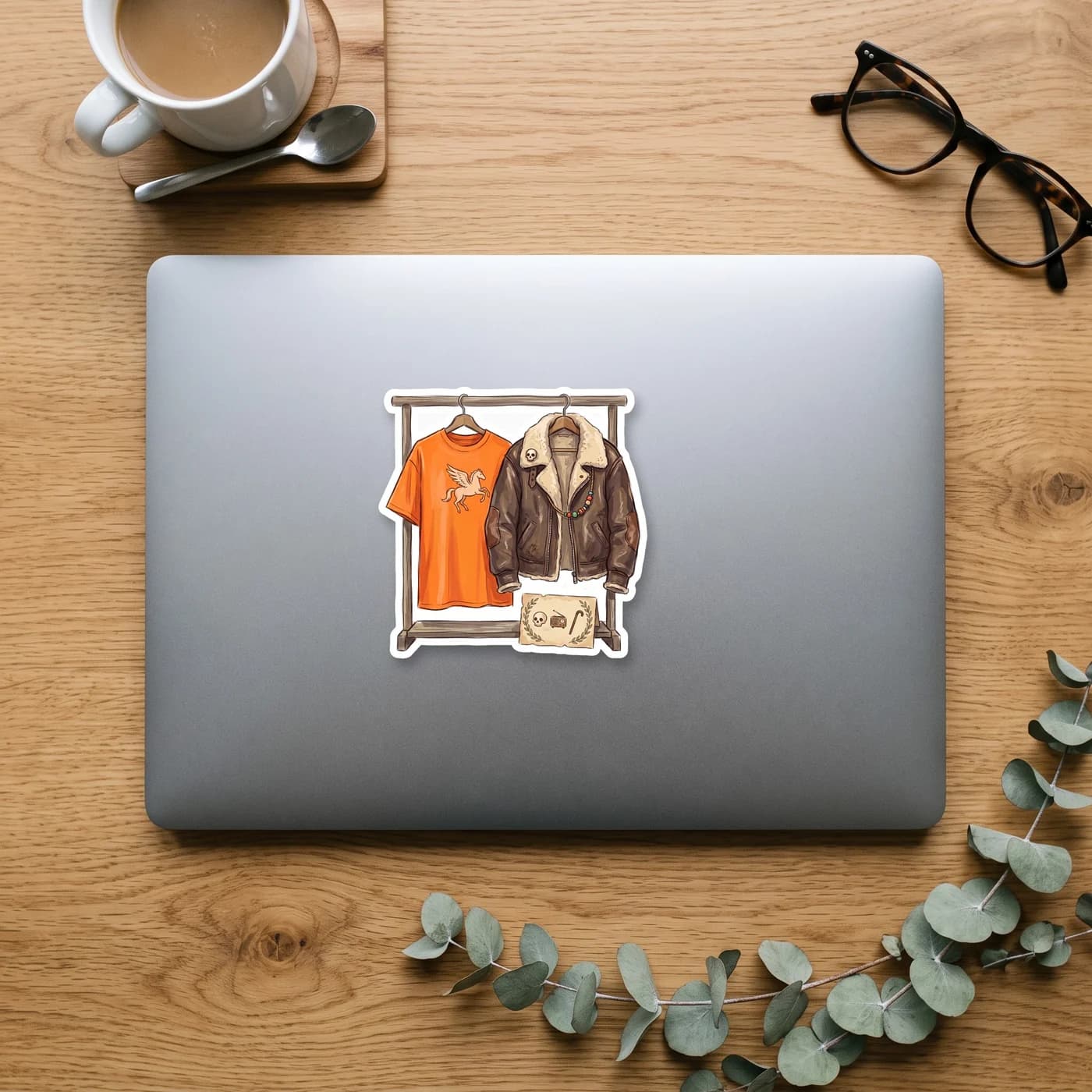 A folded pile of iconic demigod laundry featuring Nico's worn brown aviator jacket resting on top of Will's bright orange camp shirt. The clothing is draped together in a subtle nod to their relations, view 3